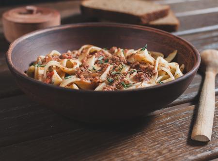 pasta tagliatelle bolognese on the wooden table
